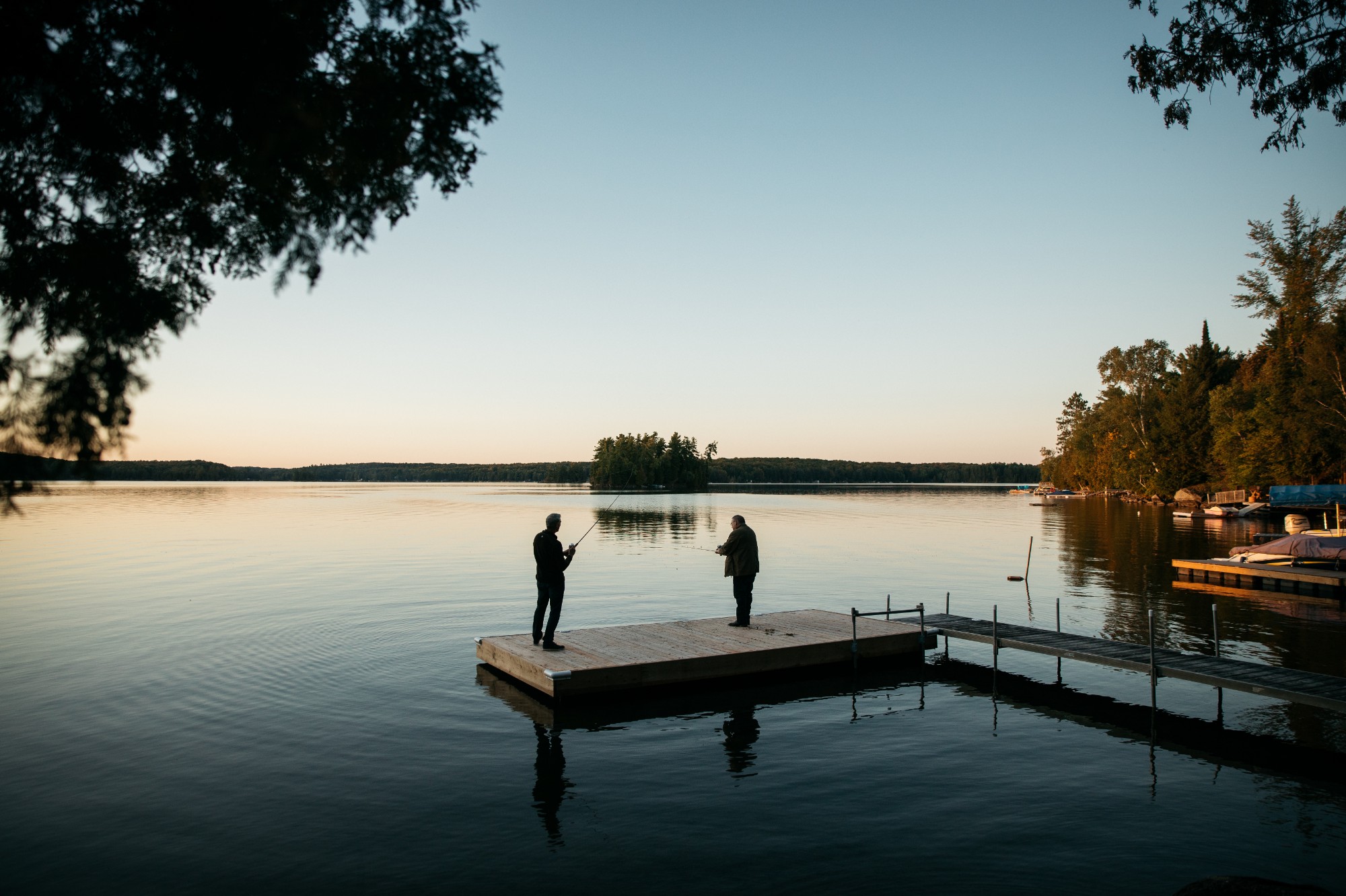 Tom Redl and Dan O'Brien fishing off a dock on Chandos Lake.