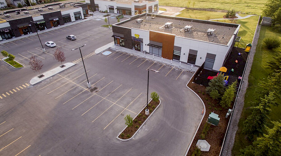 An aerial shot of the parking lot in front of the Springbank Retail building.