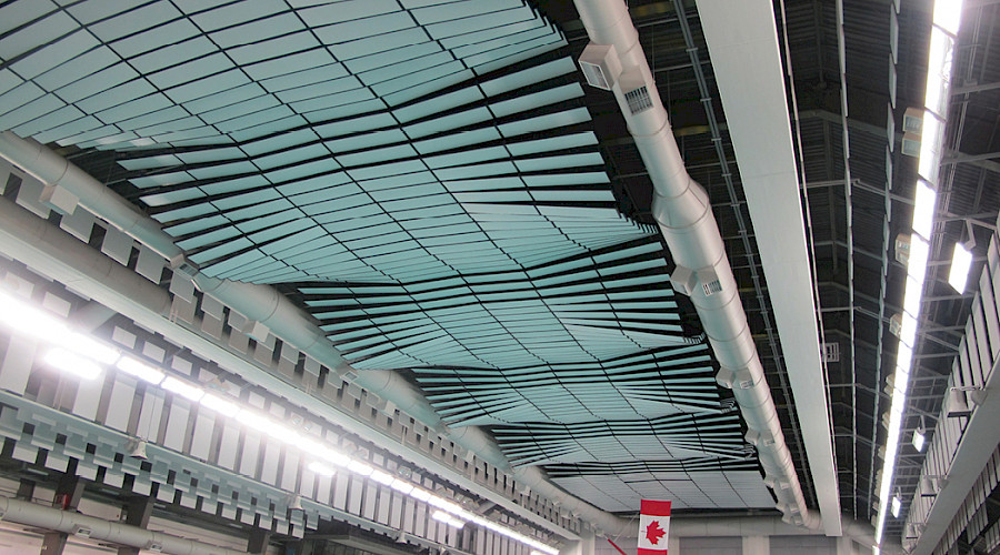A curved ceiling with the Canadian flag hanging in the distance.