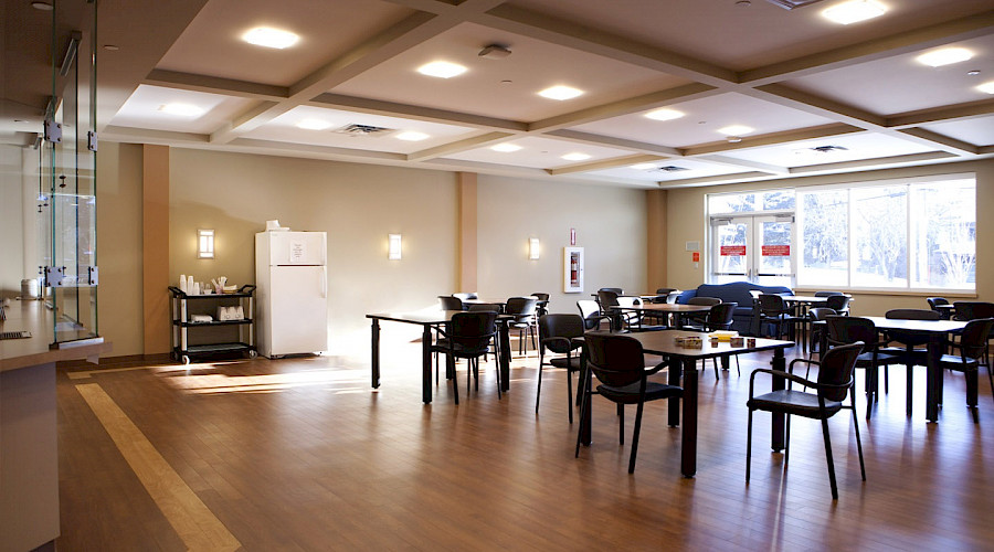 Multiple chairs and tables in a large dining hall.