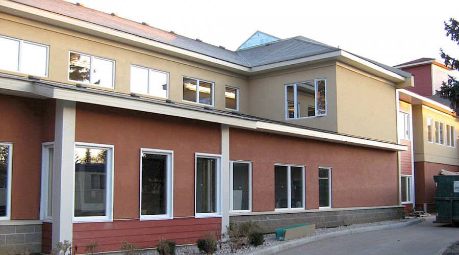 A photo of the red and yellow exterior of the Stony II Care Facility.