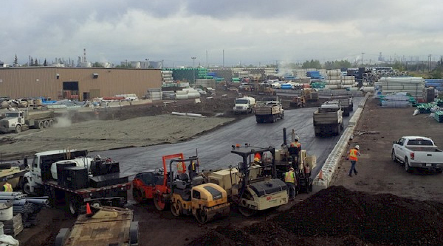 Trucks and machinery at work on a construction site.