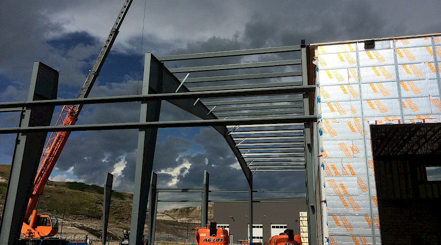 A building under construction on a grey, cloudy day.