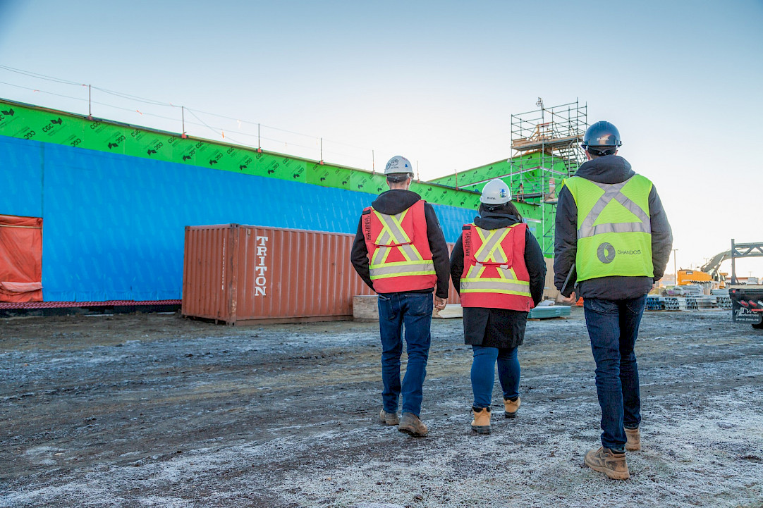 Three Chandos construction workers walking on site.