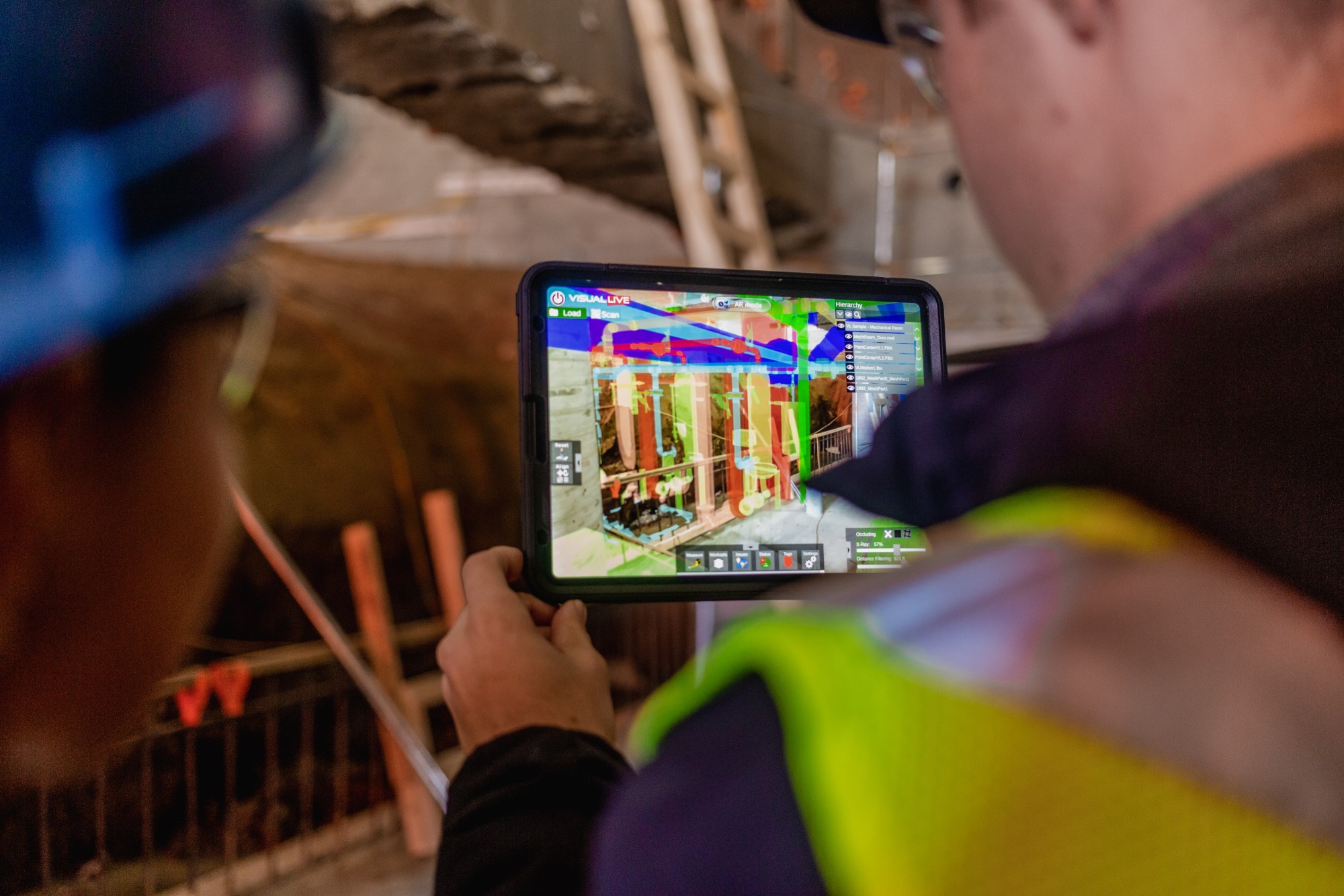 A women and a man on construction site, using design technology to virtually see completed utilities.
