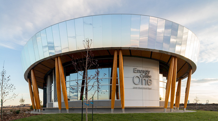 A photo of the Blatchford District Energy System featuring it's mirrored exterior reflecting a blue sky.