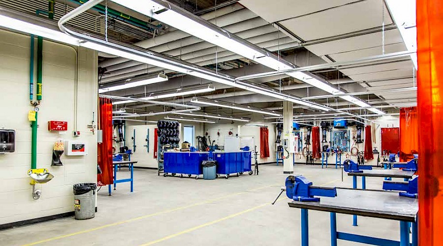 A large working classroom filled with multiple tools and working desks.