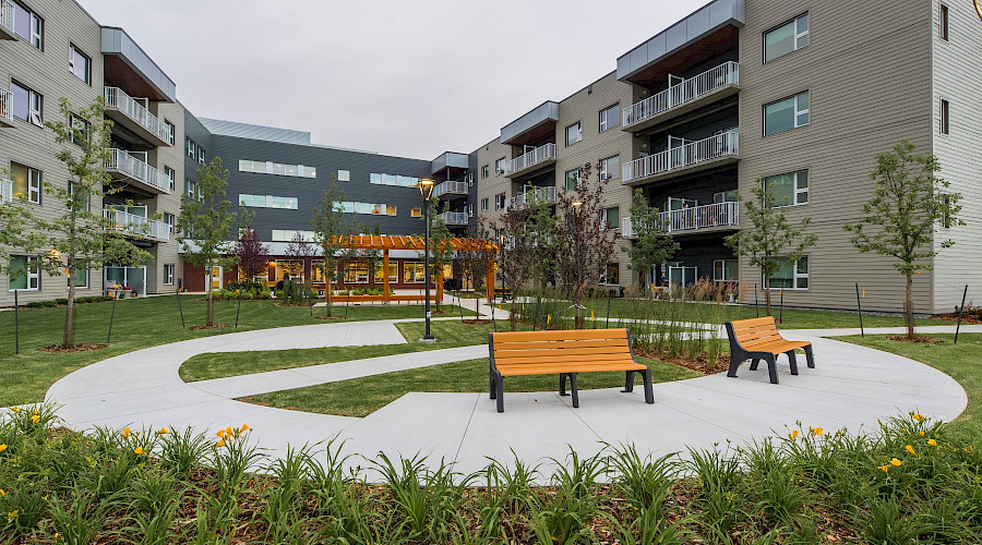 A photo of benches in a small park in the courtyard between the Sakaw Terrace buildings.