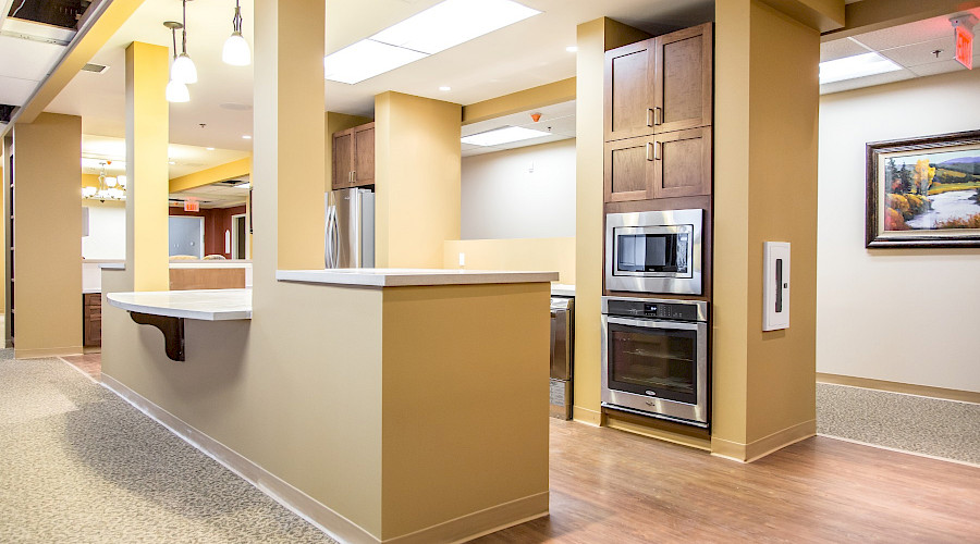 A communal kitchen in between two hallways.