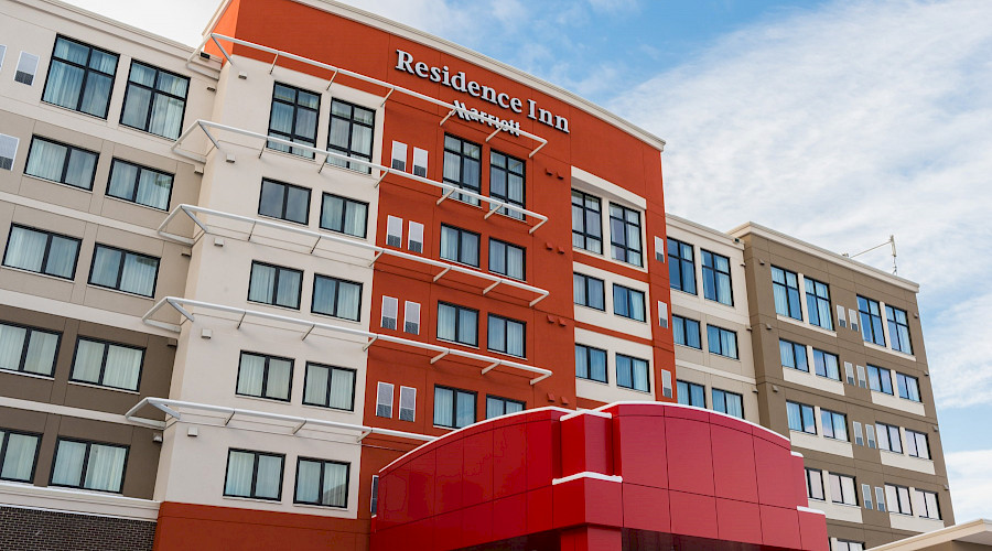 A photo of the red exterior of the Residence Inn and Courtyard by Marriott.
