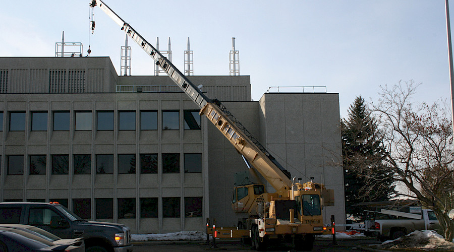A crane in front of a building.