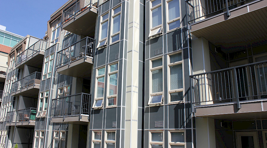A photo of the multiple windows and decks on the exterior of the Tribeca Condos.