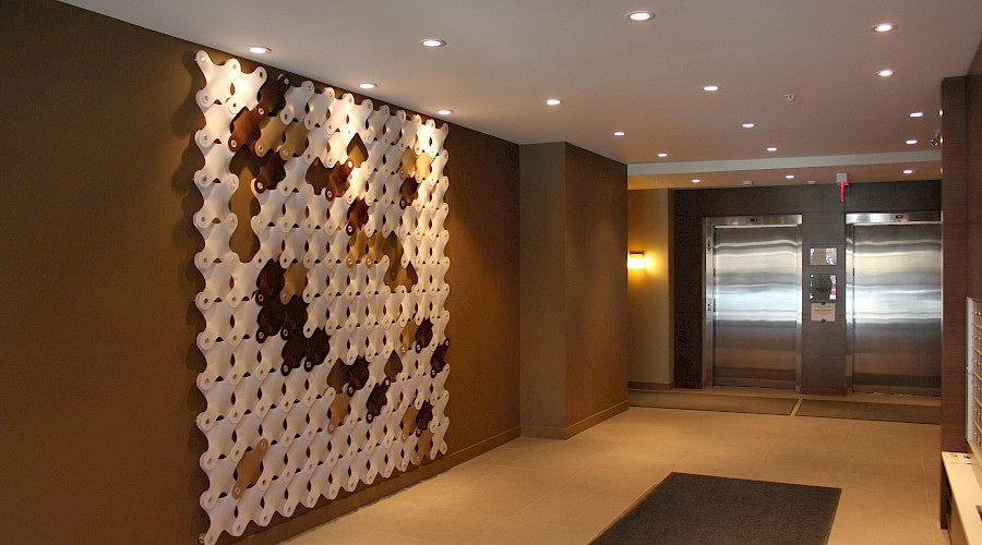A photo of an accent wall in a hallway leading to an elevator in the Tribeca condos.