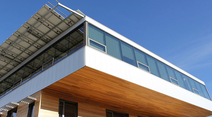 A corner of the exterior of the Mosaic Centre showcasing it's mass timber ceiling and walls.