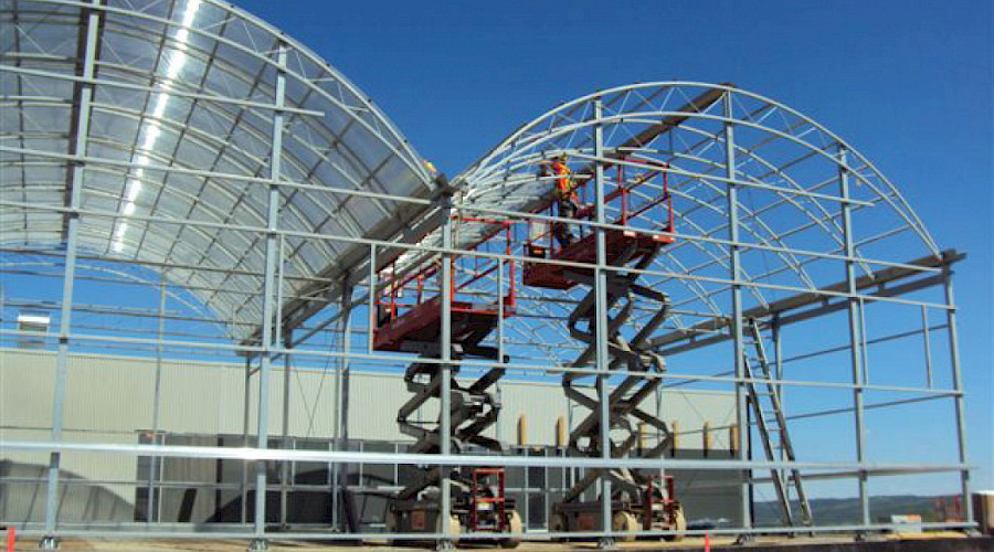 Part of the NAIT Boreal Research Facility with a bright blue sky in the background.