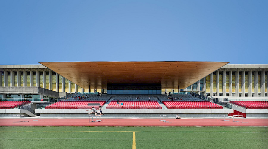 The Simon Fraser University stadium during the day with a clear blue sky in the background.