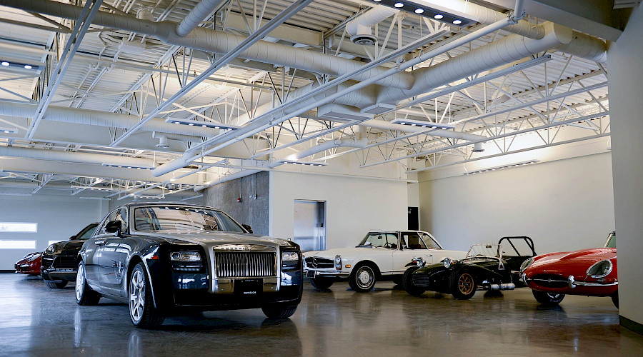 Rows of cars on display in a large room.
