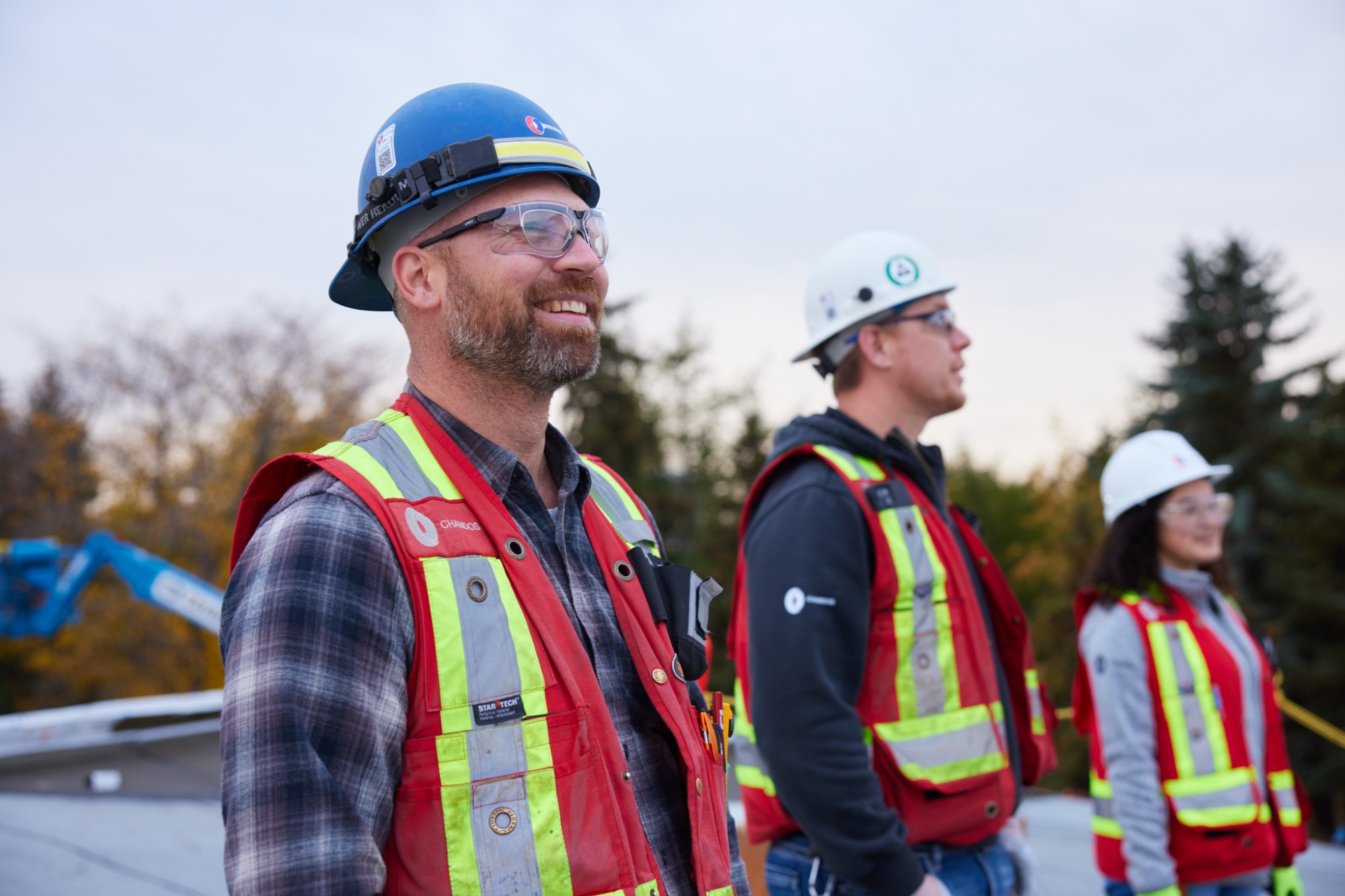 Three Chandos construction workers discussing a project on site.