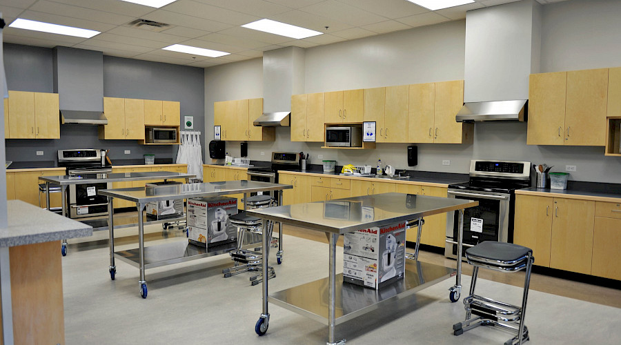 Rows of tables in a kitchen classroom.