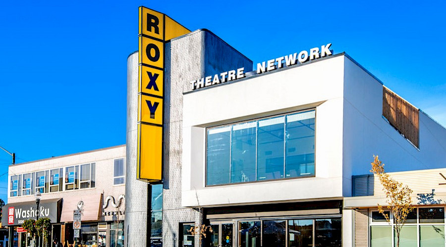 The exterior of the Roxy Theatre, featuring it's bright yellow sign.