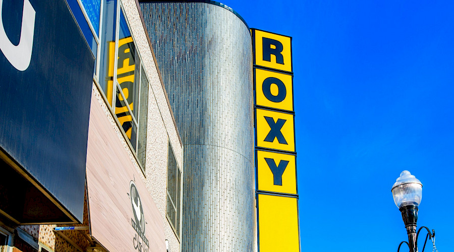 A bright yellow vertical sign that spells out 