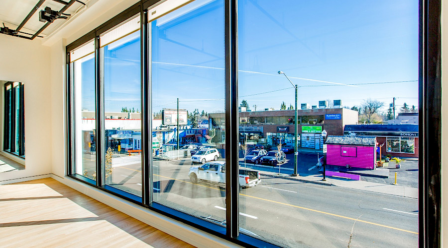 Large windows from inside the Roxy Theatre that look onto the shops across the street.