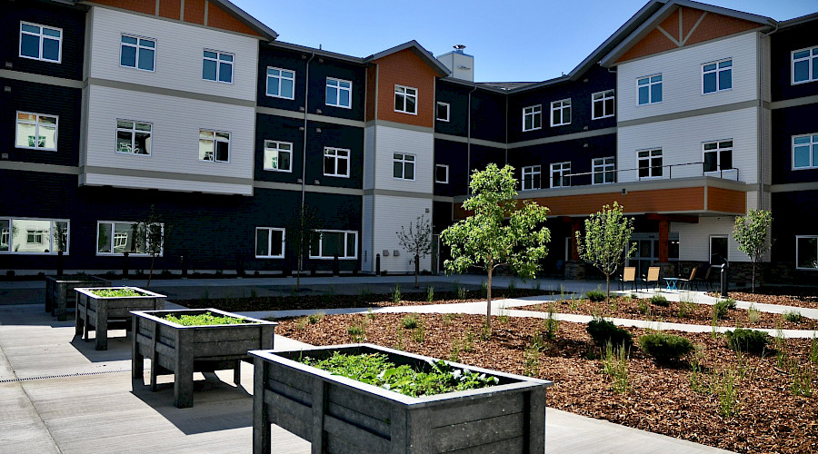 A photo of the exterior of the Crimson Villas, featuring it's small park in the front courtyard.