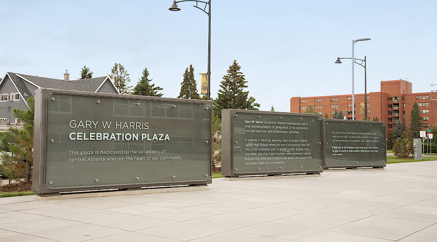 Signage in the Gary W Harris Celebration Plaza with a clear blue sky in the background.