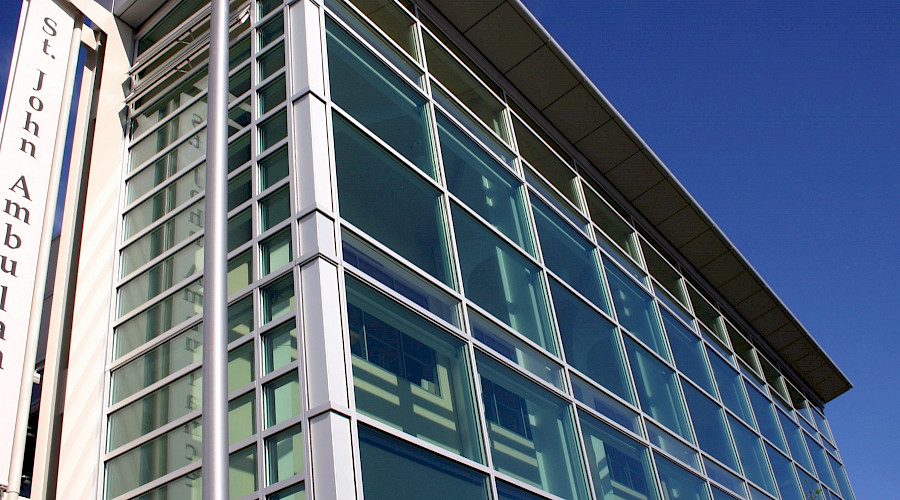 The exterior of the St. John's Ambulance building featuring many windows.