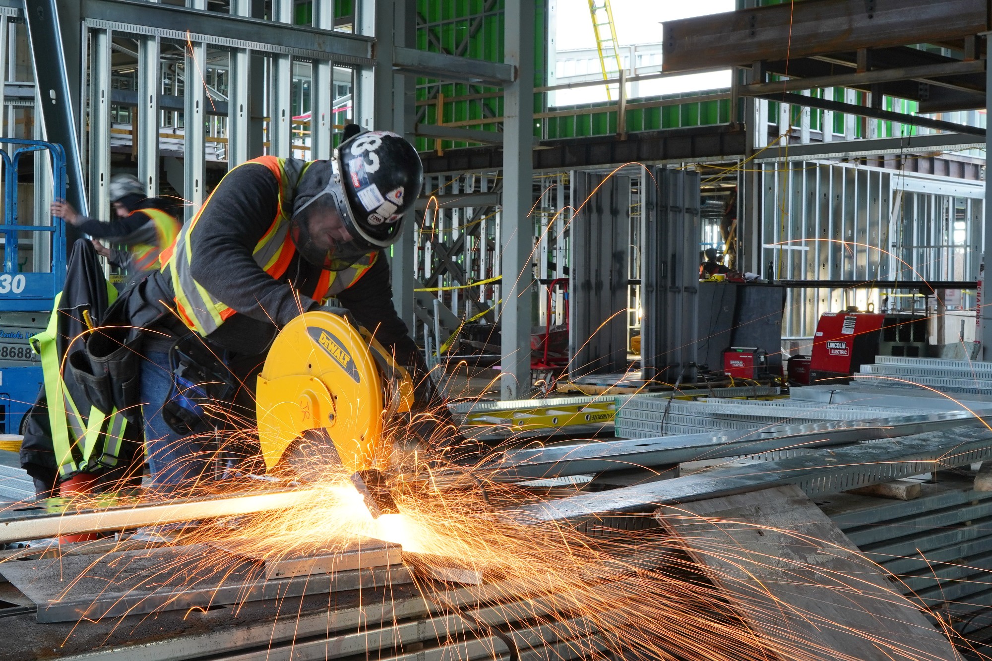 Sparks flying as a Chandos welder works on a large piece of building material on site.
