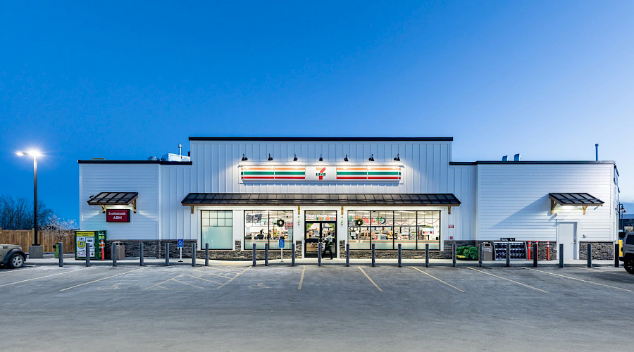 The exterior of 7-Eleven lit up in the evening.