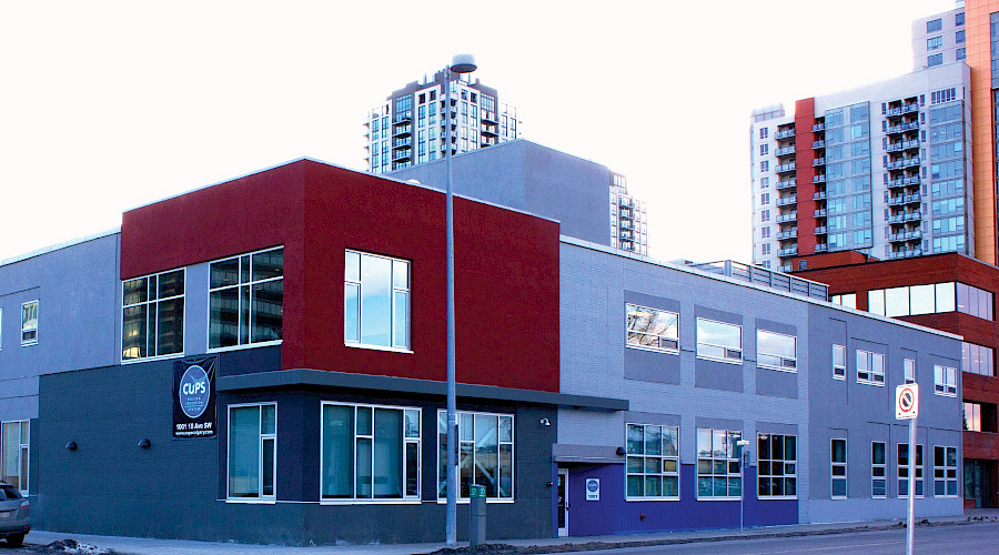 The red and grey exterior of the Calgary Urban Project Society building.