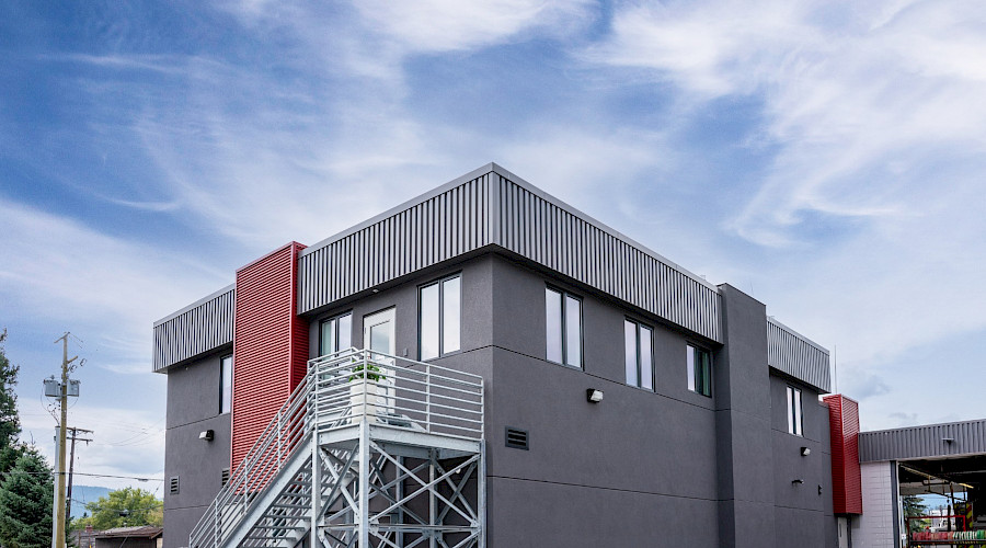 The exterior of the Merritt Firehall under a cloudy blue sky.