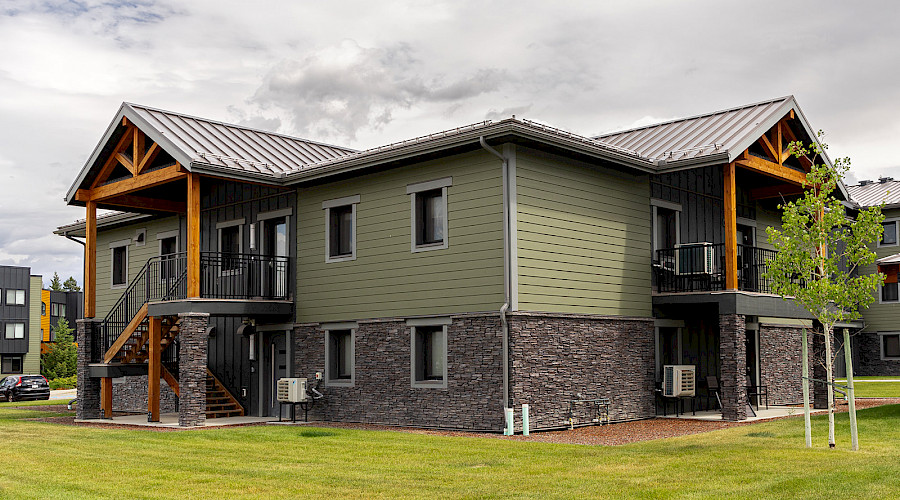 The green, stone, and wood exterior of one of the College of the Rockies buildings.