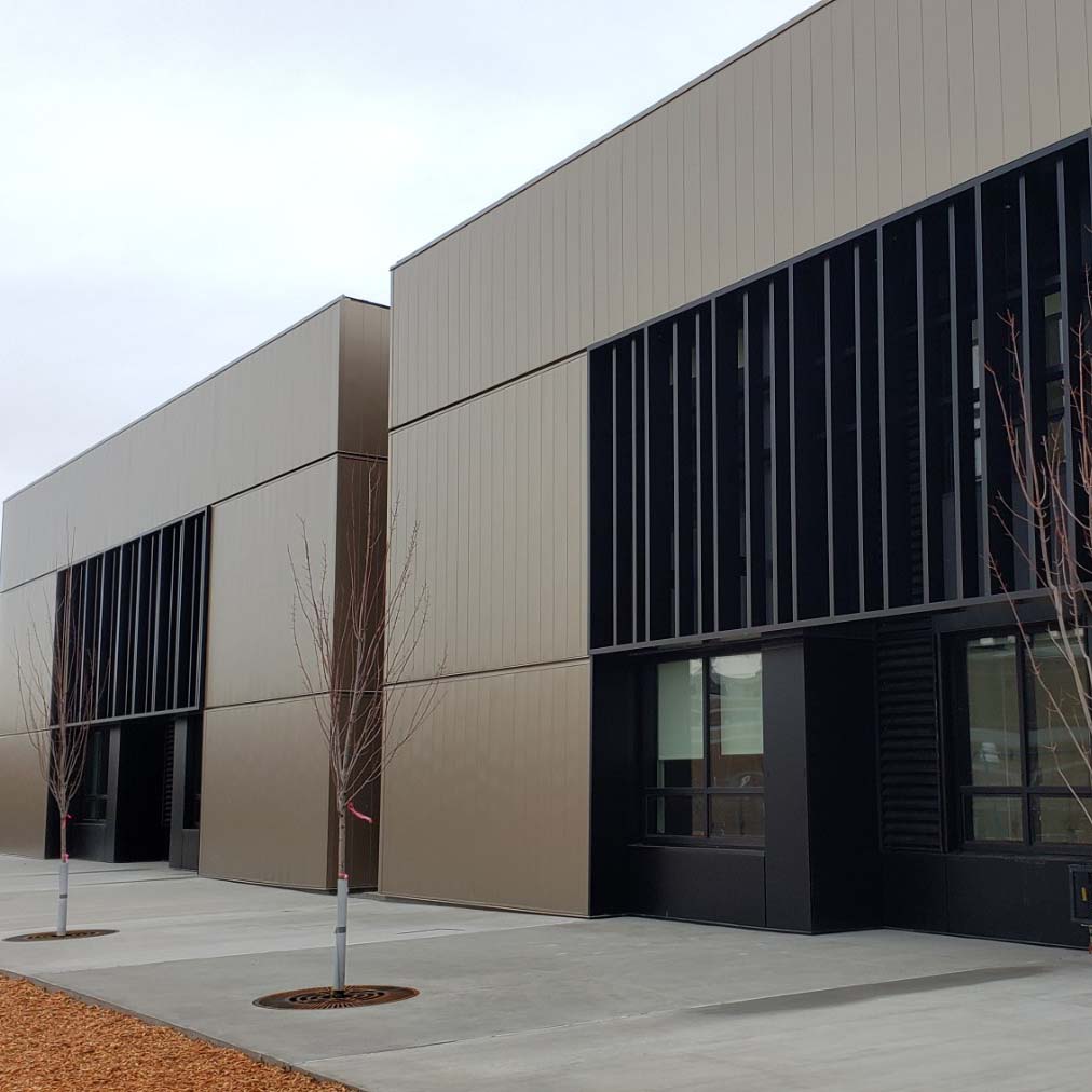 A photo of the sleek grey and black exterior of the Maple Grove Elementary school.