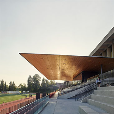 A photo of the Simon Fraser University stadium, highlighting it's mass timber roofing.