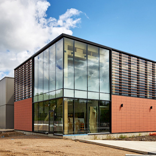 A photo of one of the buildings in the Canadian Nuclear Laboratories project, highlighting its' sky high windows and brick exterior.