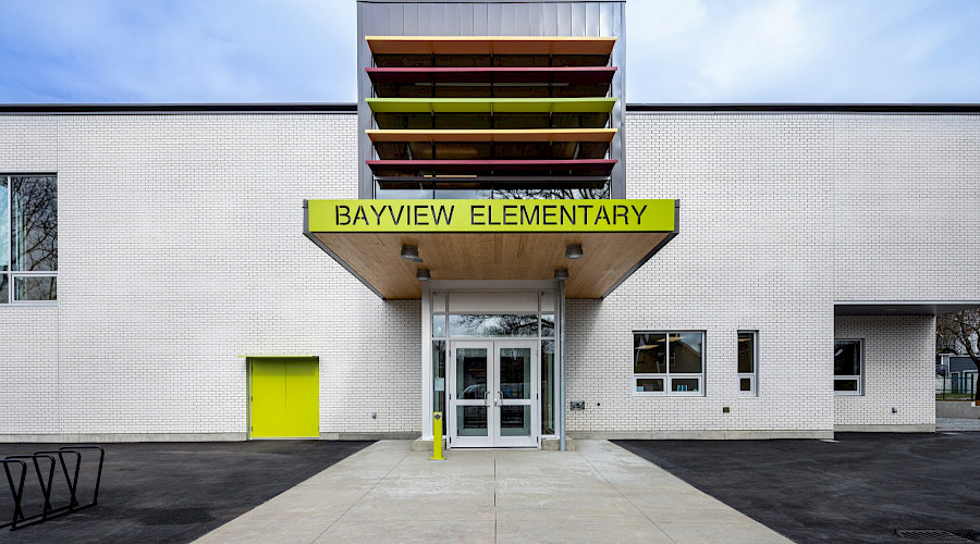 A photo of a green sign above a door that reads Bayview Elementary.