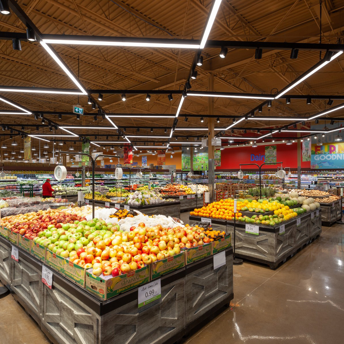 A photo of the produce section in the newly renovated Seafood City, showcasing it's lighting features and mass timber roof.