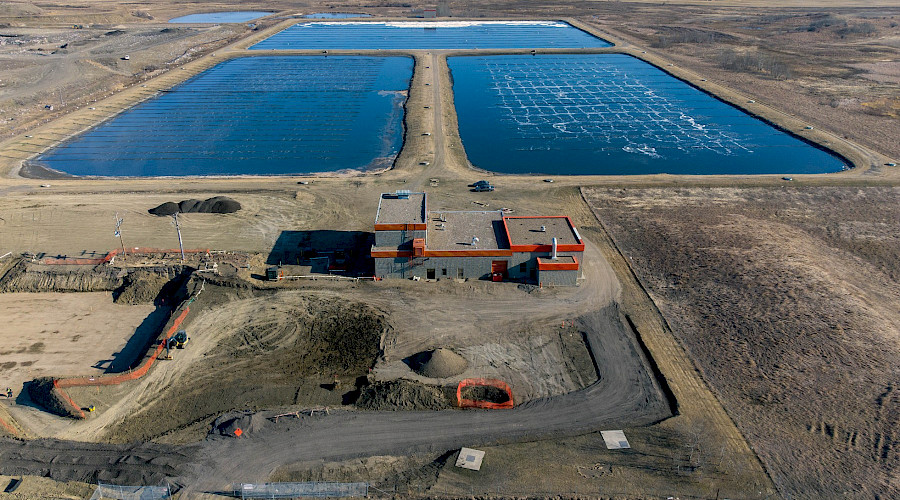 An aerial photo of the pumphouse in front of large pools of water at the Lloydminster Wastewater Treatment Facility.