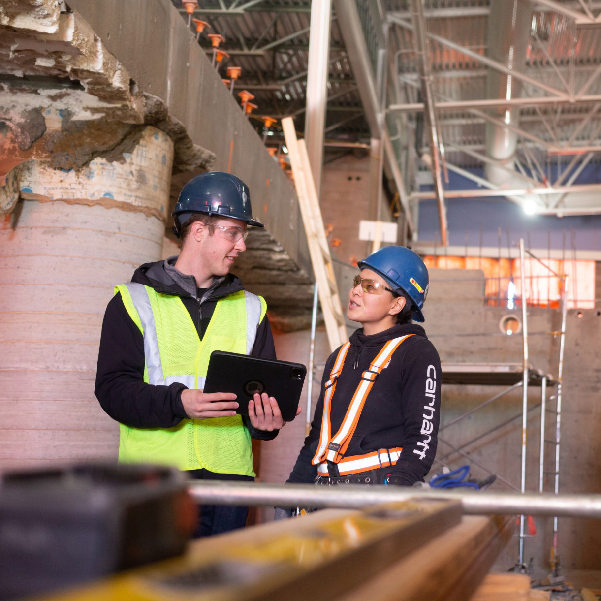 Two Chandos construction workers discussing a project on site.