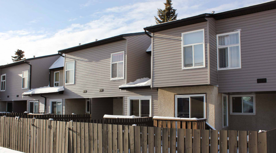 A photo of the exterior of multiple houses from the back.