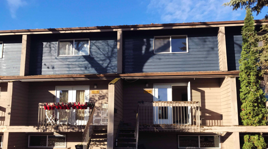 A photo of the front doors of two houses directly next to each other.