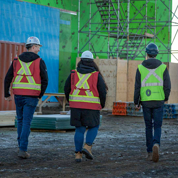Three Chandos employees, walking on a construction site in Drayton Valley Alberta