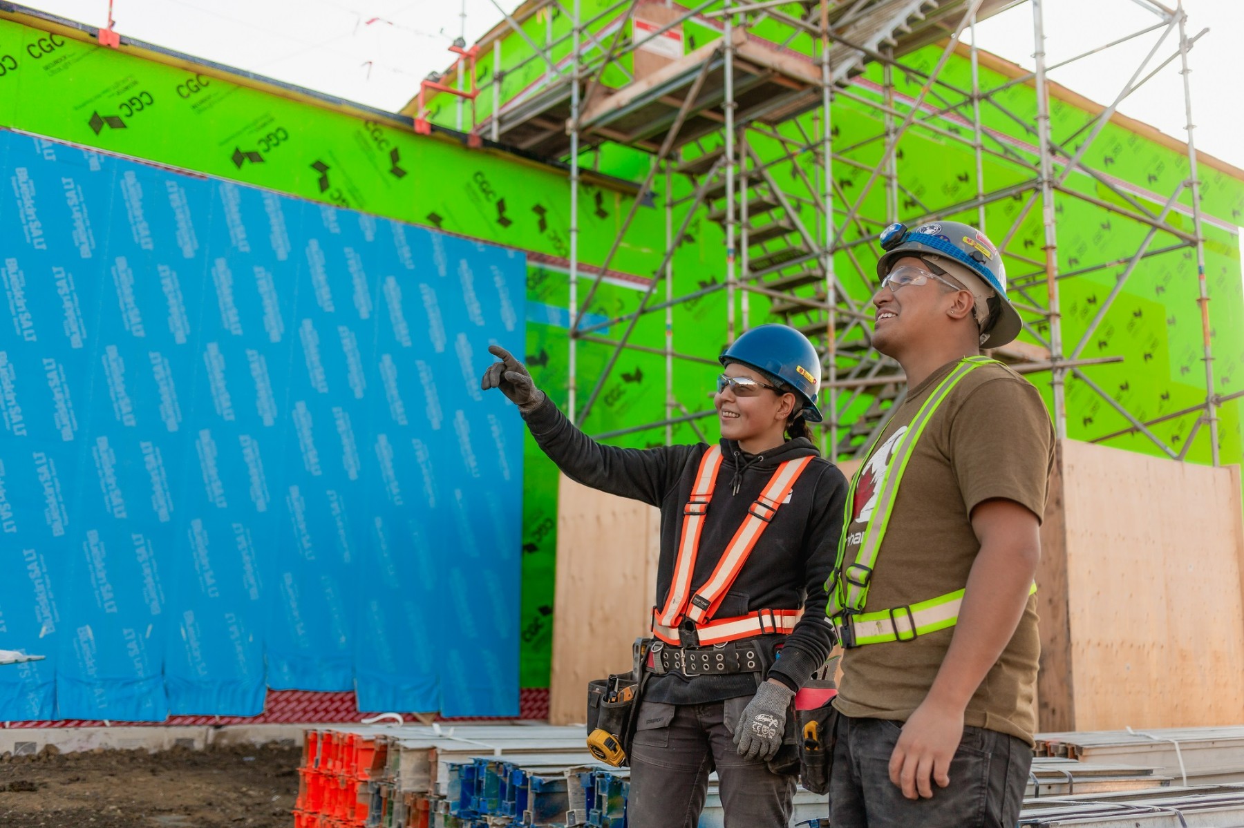 Two Chandos construction workers discussing a project on site.