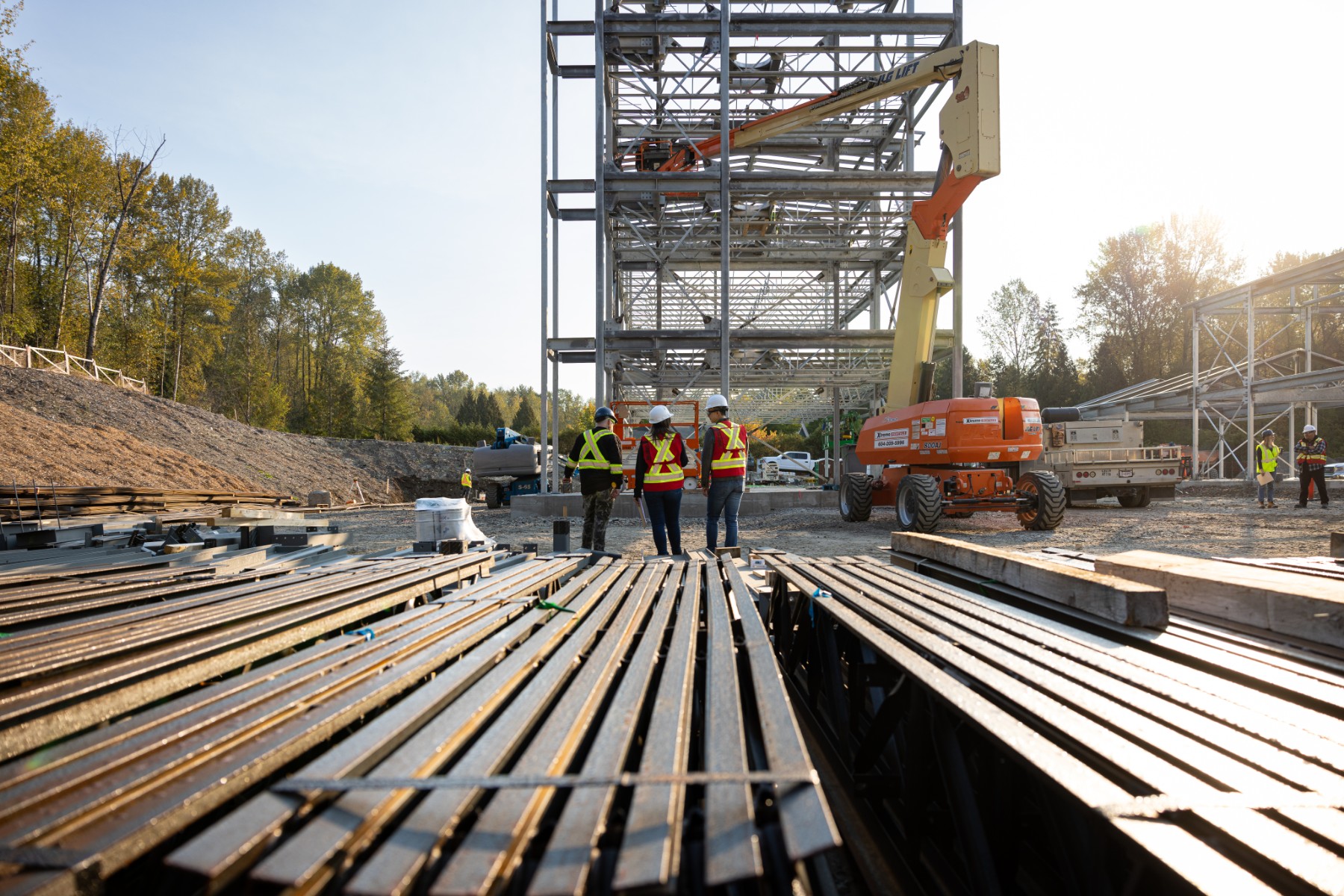 Three Chandos construction workers walking together in the distance on a project site.