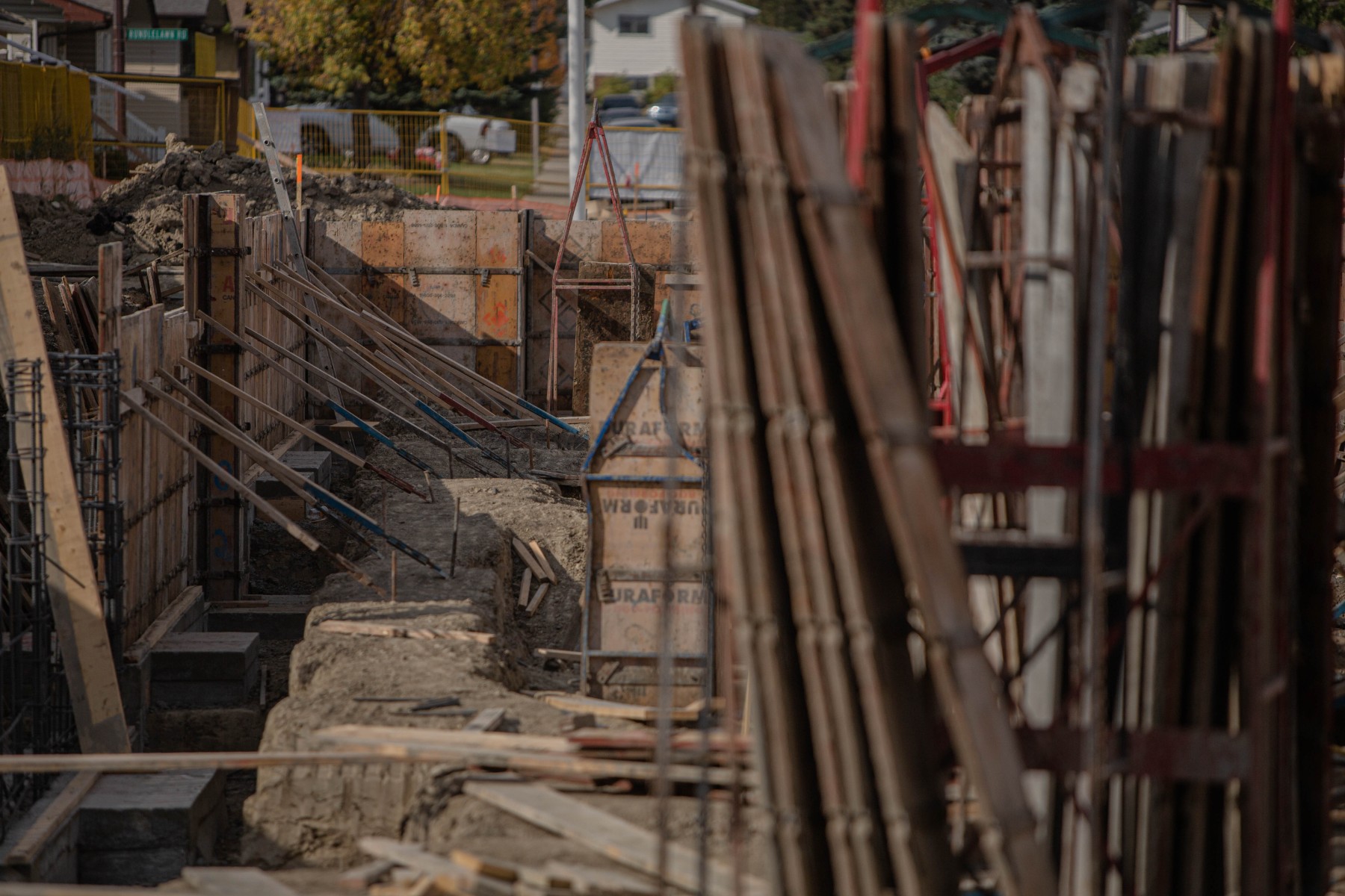 A photo of construction material like mass timber on a construction project site.