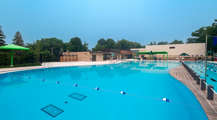 4. Wide angle shot of the pool, changeroom and administration facility, and shade structure from the deep end.