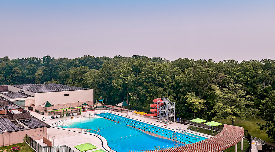 Aerial side view of Burlington Mountainside Pool, shade structure, pool, change room facility, self-performed concrete work, and wading entrance.