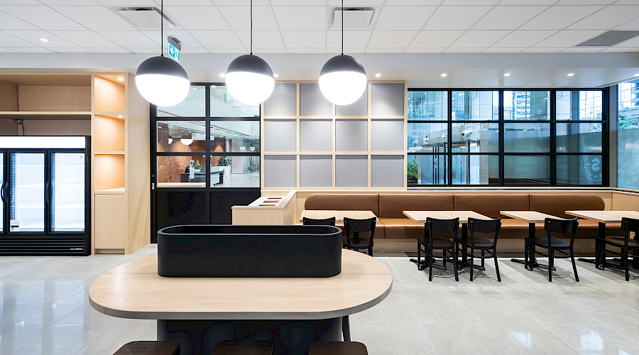 Image of the Seed n Salt dining room with light oak wall fixtures, window fixtures, and leather seating completed by Chandos Construction Calgary.